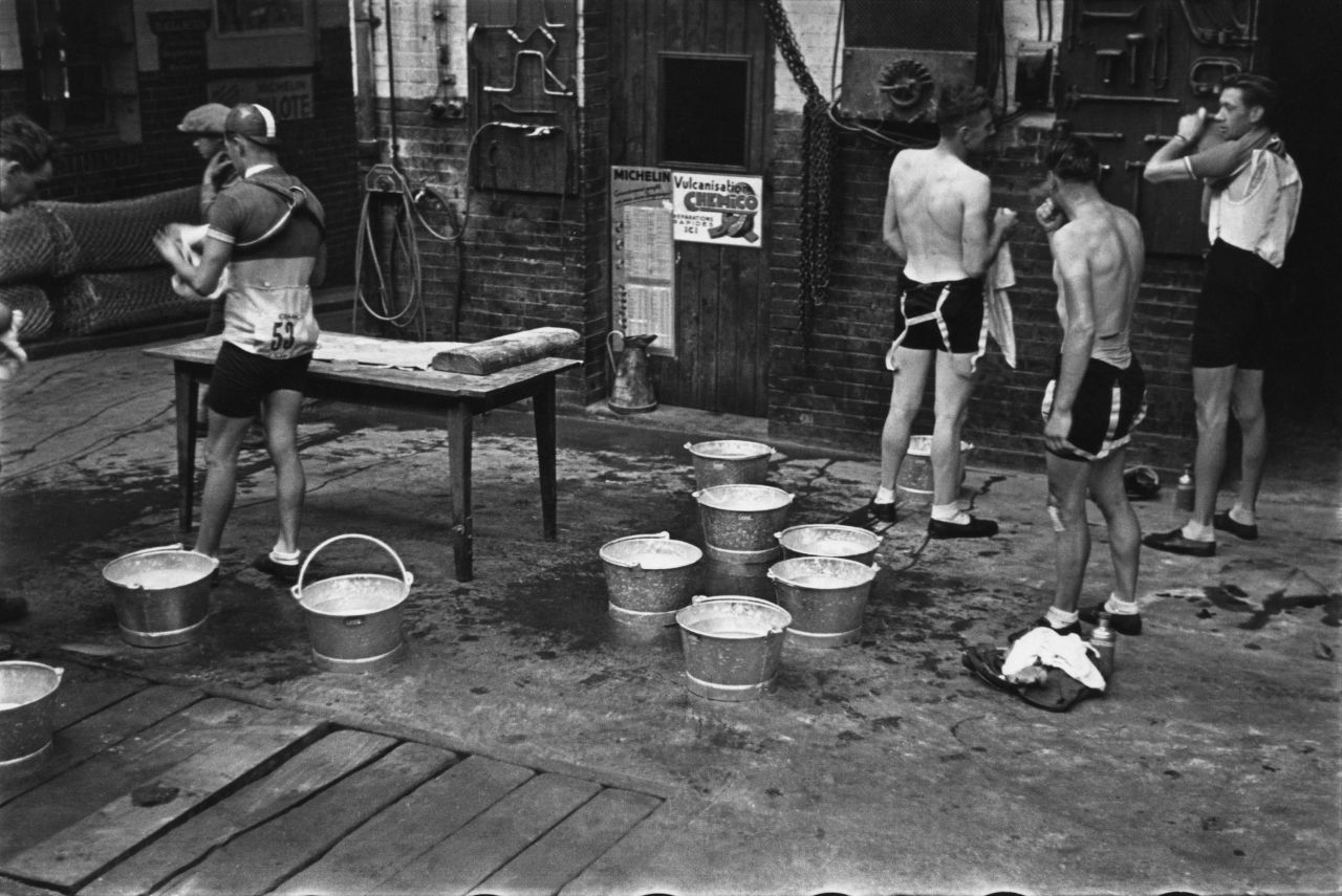 Nowadays, cyclists are on teams funded by major corporate sponsors. They have doctors, dietitians and other specialists on staff catering to their every need. The situation was a little more austere in the '30s. Here, the cyclists stop for the day to rest, wash and clean up.