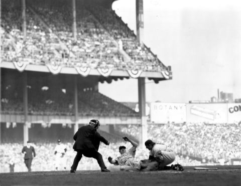 Yankees catcher Yogi Berra tags sliding Philadelphia Phillies shortstop Granny Hamner to complete a double play in Game 4 of the 1950 World Series at Yankee Stadium. Berra won 10 World Series as a player with the Yankees and a further three as a coach. 