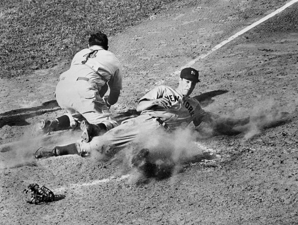 The Yankees' Joe DiMaggio slides safely into home plate for the tying run in the ninth inning of Game 4 of the 1939 World Series against the Cincinnati Reds. The Yankees swept the series 4-0, while DiMaggio would win nine World Series during his career.
