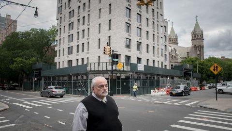 Guy Aiossa stands outside the new site for a SAGE building in Brooklyn.