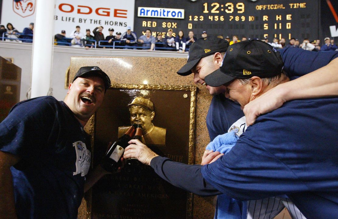 David Wells (L), Roger Clemens (C) and pitching coach Mel Stottlemyre celebrate in Yankee Stadium with the plaque of Babe Ruth after defeating the Boston Red Sox in Game 7 of the ALCS in 2003. The Curse of the Bambino would be broken the following year in a playoff rematch between the teams.  