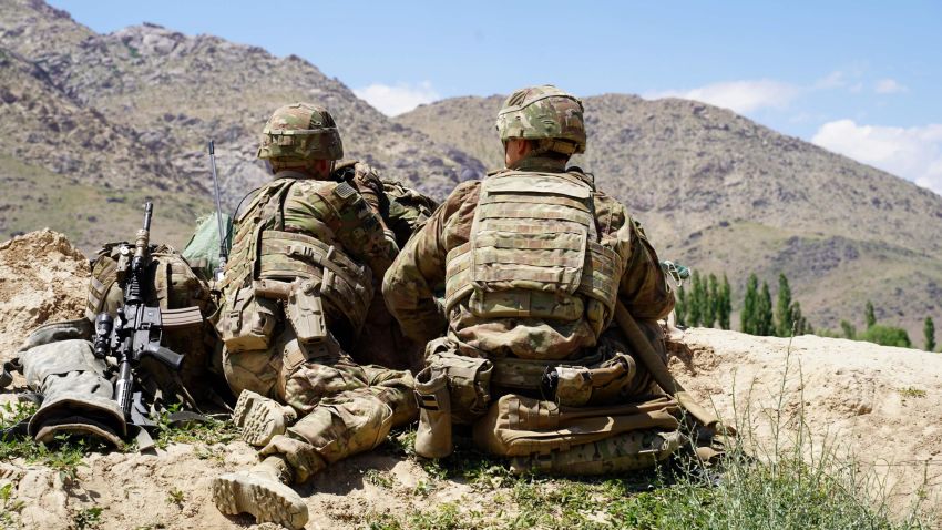 In this photo taken on June 6, 2019, US soldiers look out over hillsides during a visit of the commander of US and NATO forces in Afghanistan General Scott Miller at the Afghan National Army (ANA) checkpoint in Nerkh district of Wardak province. - A skinny tangle of razor wire snakes across the entrance to the Afghan army checkpoint, the only obvious barrier separating the soldiers inside from any Taliban fighters that might be nearby. (Photo by THOMAS WATKINS / AFP) / To go with 'AFGHANISTAN-CONFLICT-MILITARY-US,FOCUS' by Thomas WATKINS        (Photo credit should read THOMAS WATKINS/AFP/Getty Images)