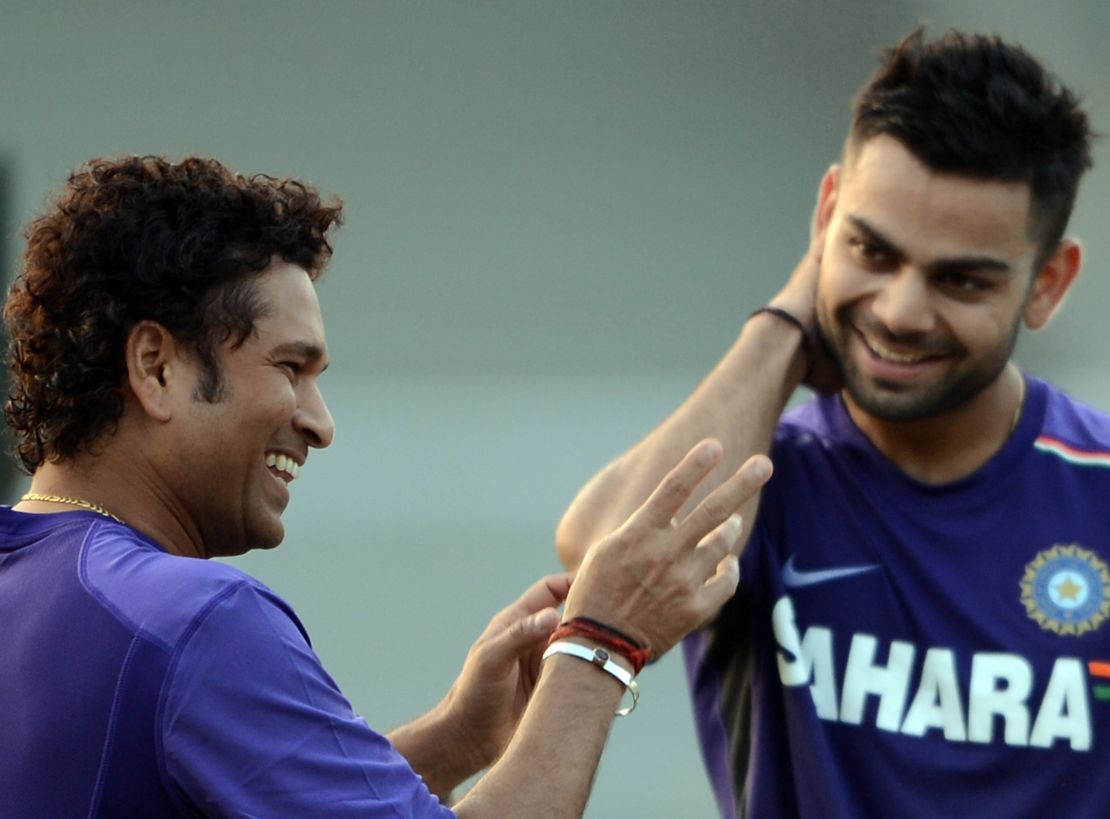 Tendulkar shares a light moment with Kohli during a training session in Mumbai on November 9, 2012. 