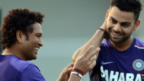 Tendulkar shares a light moment with Kohli during a training session in Mumbai on November 9, 2012. 