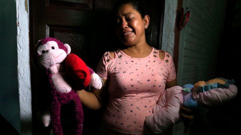 Rosa Ramirez sobs as she shows journalists toys that belonged to her granddaughter Angie Valeria in her home in San Martin, El Salvador, on Tuesday. 