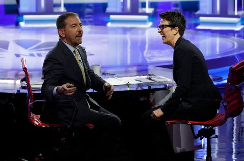 NBC moderator Chuck Todd speaks to the audience during a technical problem in Wednesday's debate. As microphone issues continued, Todd was forced to cut to a commercial break. At right is moderator Rachel Maddow.