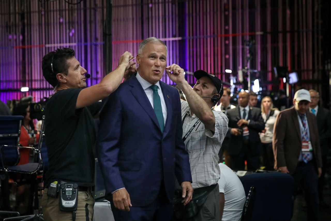 Inslee gets a microphone attached to him for a television interview in June 2019. It was just before the first Democratic debates.