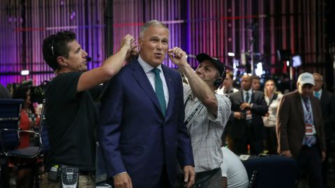 Inslee gets a microphone attached to him for a television interview in June 2019. It was just before the first Democratic debates.
