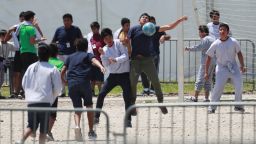 FILE - In this April 19, 2019 file photo, Migrant children play soccer at the Homestead Temporary Shelter for Unaccompanied Children on Good Friday in Homestead, Fla. Immigrant advocates say the U.S. government is allowing migrant children at a Florida facility to languish in "prison-like conditions" after crossing the U.S.-Mexico border instead of releasing them promptly to family as required by federal rules. A court filing Friday, May 31, 2019 revealed conditions inside the Homestead, Florida, facility that has become the nation's biggest location for detaining immigrant children. (AP Photo/Wilfredo Lee, File)