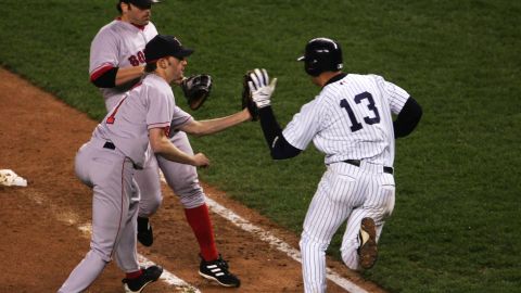 Bronson Arroyo of the Red Sox has the ball knocked out of his glove by Alex Rodriguez of the New York Yankees on a tag-out as first baseman Kevin Millar looks on in the eighth inning during Game 6 of the American League Championship Series on October 19, 2004 at Yankee Stadium.