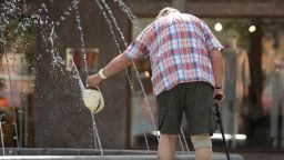 A man cools off in a water fountain at Parc de Sa Riera in Palma de Mallorca, on June 26, 2019 at the start of a heatwave tipped to break records across Europe. - Experts say such heatwaves early in the summer are likely to be more frequent as the planet heats up -- a phenomenon that scientists have shown to be driven by human use of fossil fuels. (Photo by JAIME REINA / AFP)        (Photo credit should read JAIME REINA/AFP/Getty Images)