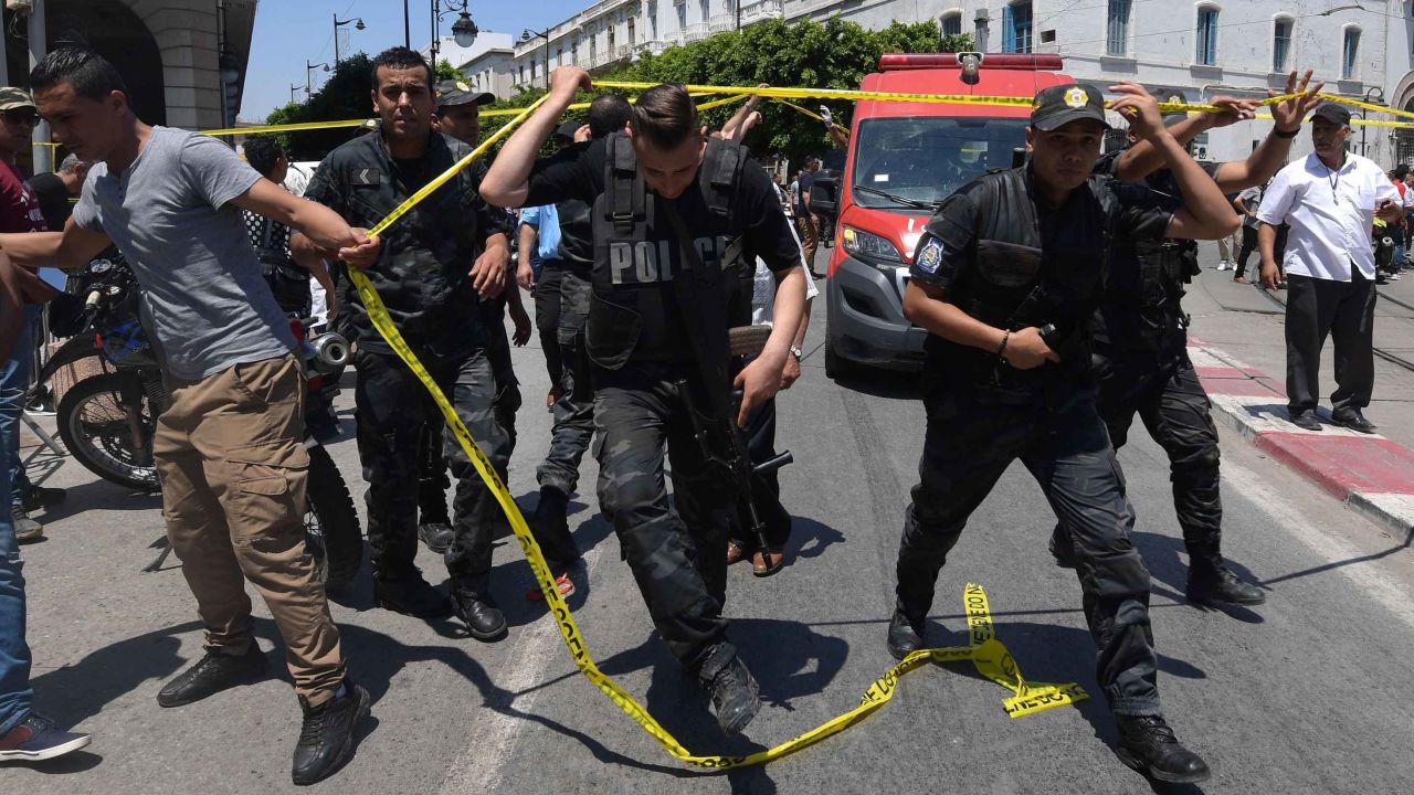 Tunisian police work at the site of one of  Thursday's attacks.