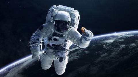In this photo illustration provided in a press release by DoubleTree, an astronaut holds a cookie in space. 