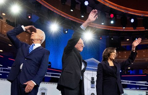 From left, Biden, Sanders and Harris arrive on stage for Thursday's debate.