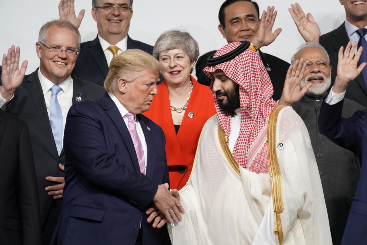 Bin Salman shakes hands with Trump during a photo session Friday at the G20 summit.