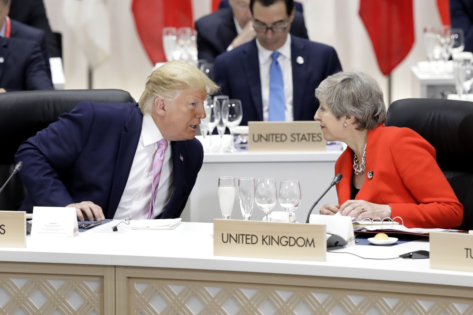 US President Donald Trump speaks to British Prime Minister Theresa May before a working lunch at the G20 summit.