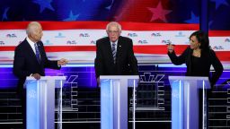 MIAMI, FLORIDA - JUNE 27: Sen. Kamala Harris (R) (D-CA) and former Vice President Joe Biden (L) speak as Sen. Bernie Sanders (I-VT) looks on during the second night of the first Democratic presidential debate on June 27, 2019 in Miami, Florida.  A field of 20 Democratic presidential candidates was split into two groups of 10 for the first debate of the 2020 election, taking place over two nights at Knight Concert Hall of the Adrienne Arsht Center for the Performing Arts of Miami-Dade County, hosted by NBC News, MSNBC, and Telemundo. (Photo by Drew Angerer/Getty Images)