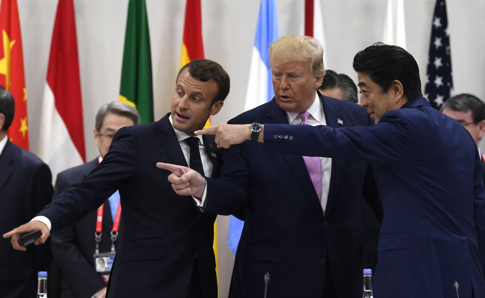 French President Emmanuel Macron, President Donald Trump and Japanese Prime Minister Shinzo Abe speak before a working session at the G20 summit on Friday, June 28. 
