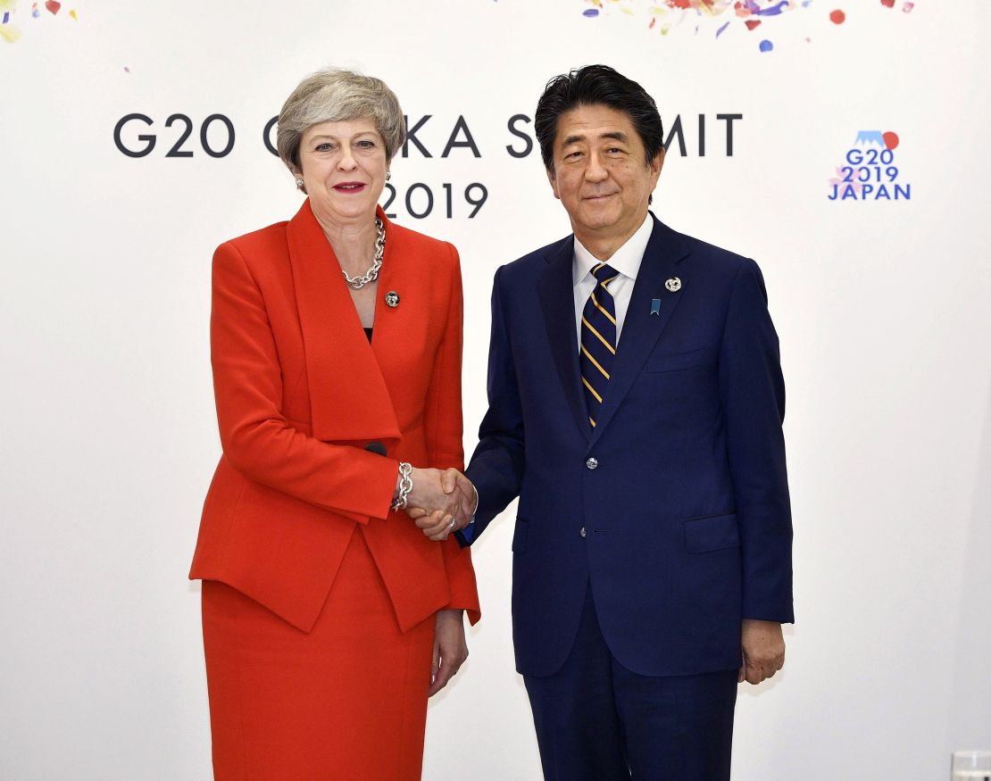 Theresa May looked happier when meeting Japanese Prime Minister Shinzo Abe at the same event.