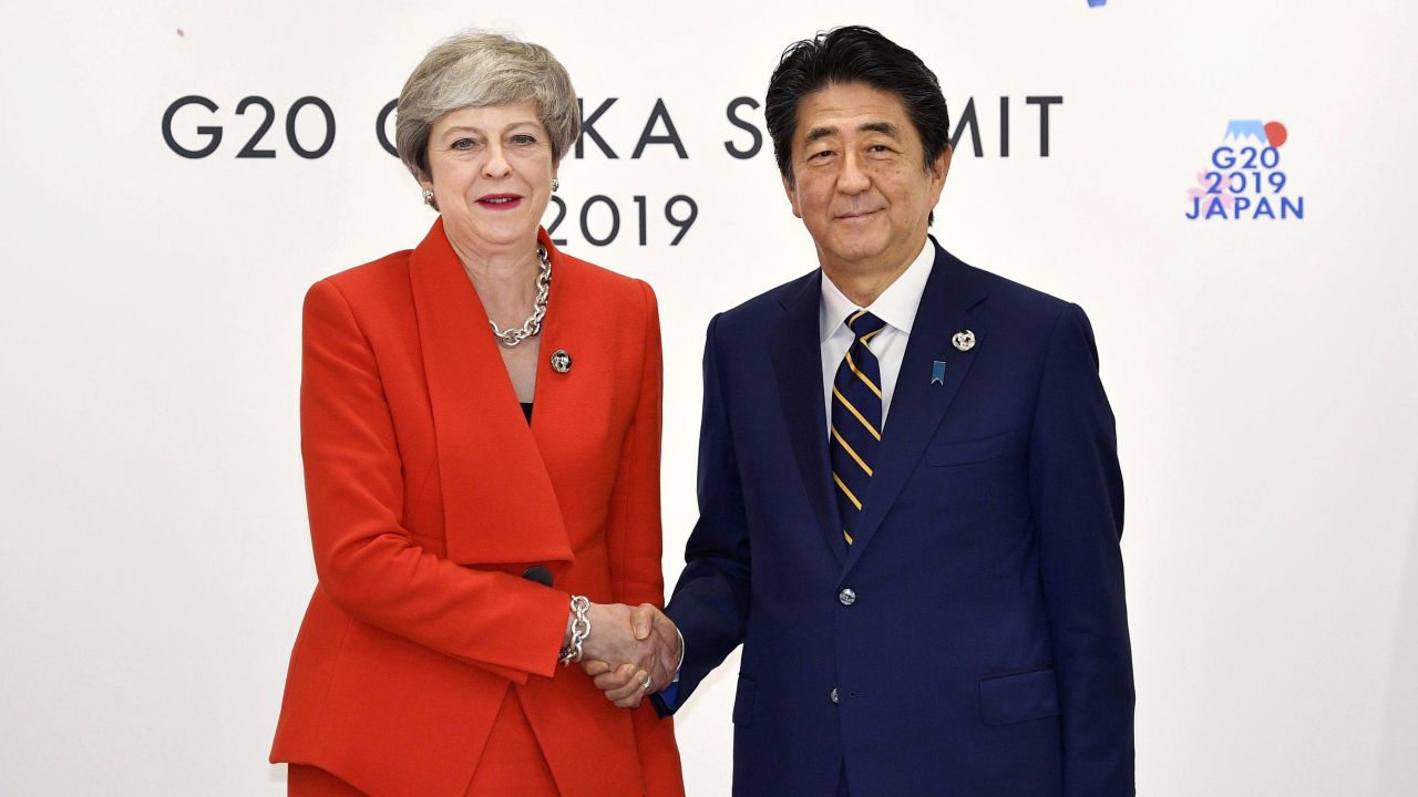 Theresa May looked happier when meeting Japanese Prime Minister Shinzo Abe at the same event.