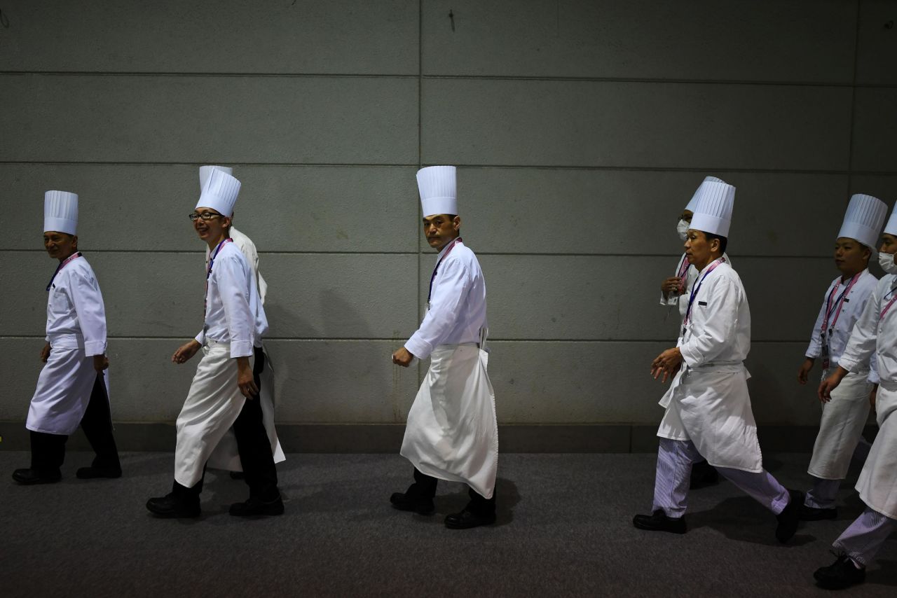 Chefs walk backstage Friday at the G20 summit.  