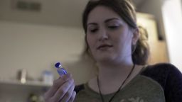 Rebecca Carpenter-Dehoff looks at her last vial of insulin before her trip to Canada. 