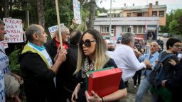 Marija Lukic (C), flanked by her lawyers, walks past supporters of Milutin Jelicic-Jutka demonstrating as she arrives at a local court to attend the trial for sexual harassment of former Mayor of Brus, Milutin Jelicic-Jutka (unseen), on May 27, 2019 in the Serbian southern town of Brus. - Marija Lukic, 31-year-old, accused her former boss, the mayor of her small Serbian town, Milutin Jelicic-Jutka, of repeated sexual assault and harassment in the workplace. Jelicic-Jutka, who has denied all accusations, resigned in March, a year after he was charged by police. (Photo by OLIVER BUNIC / AFP)        (Photo credit should read OLIVER BUNIC/AFP/Getty Images)