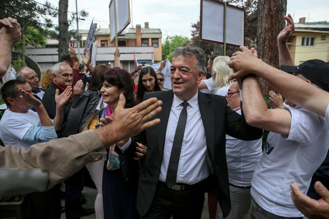 The former mayor of Brus, Milutin Jelicic is welcomed by supporters as he arrives at court on May 27 to attend his trial for sexual harassment.