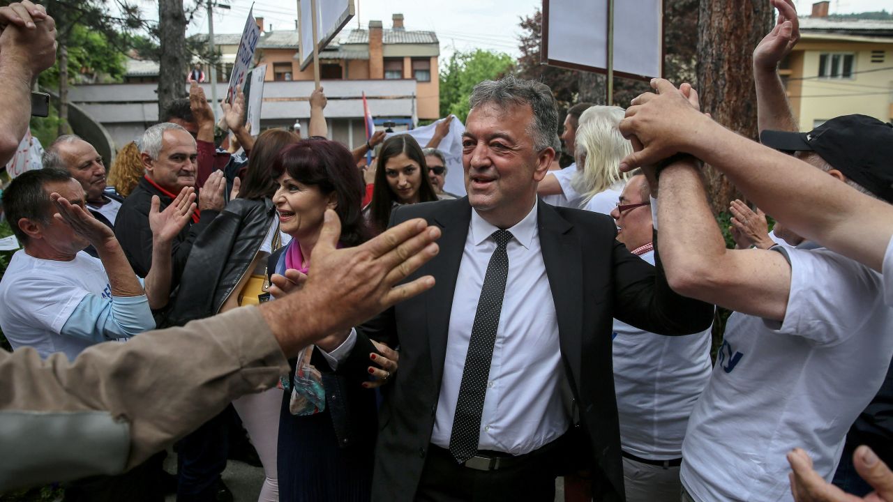 The former mayor of Brus, Milutin Jelicic is welcomed by supporters as he arrives at court on May 27 to attend his trial for sexual harassment.