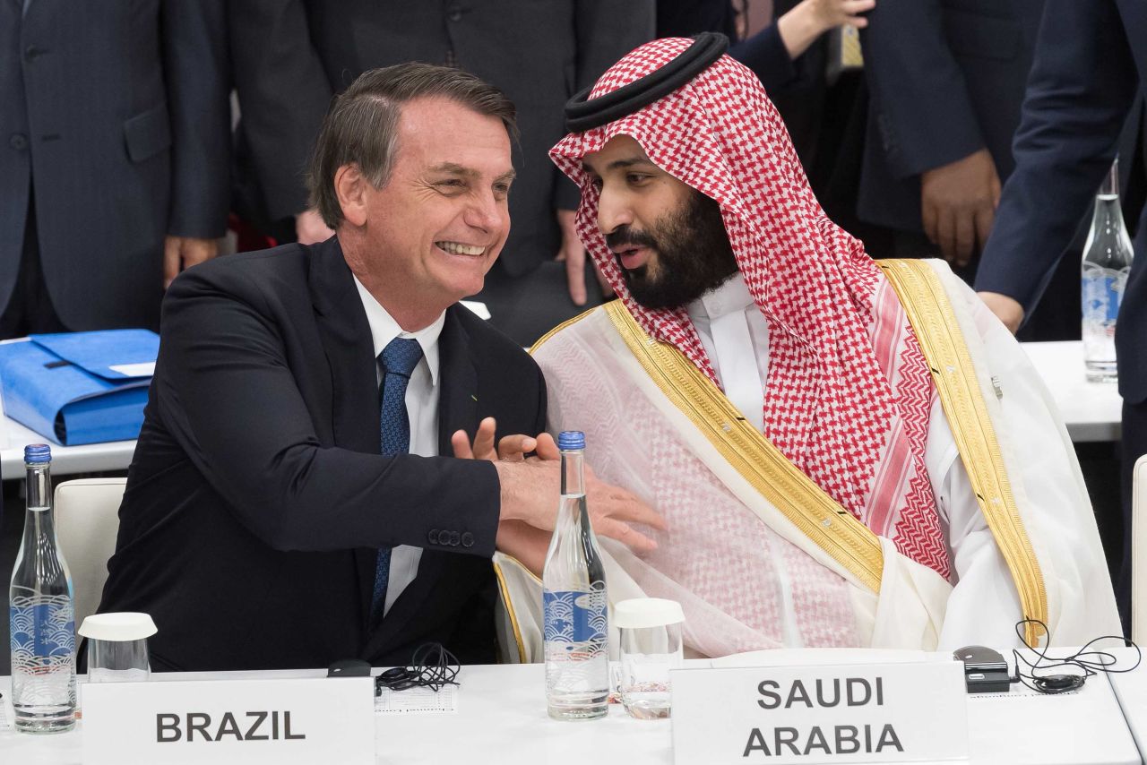 President Jair Bolsonaro of Brazil shakes hands Friday with bin Salman at the G20 summit.