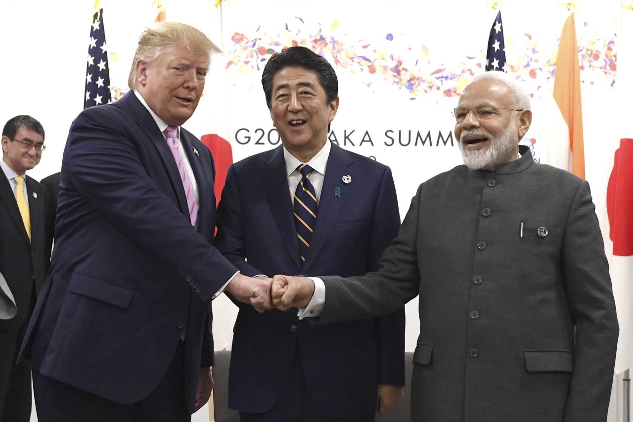 Trump fist-bumps Abe, center, and Indian Prime Minister Narendra Modi on Friday.