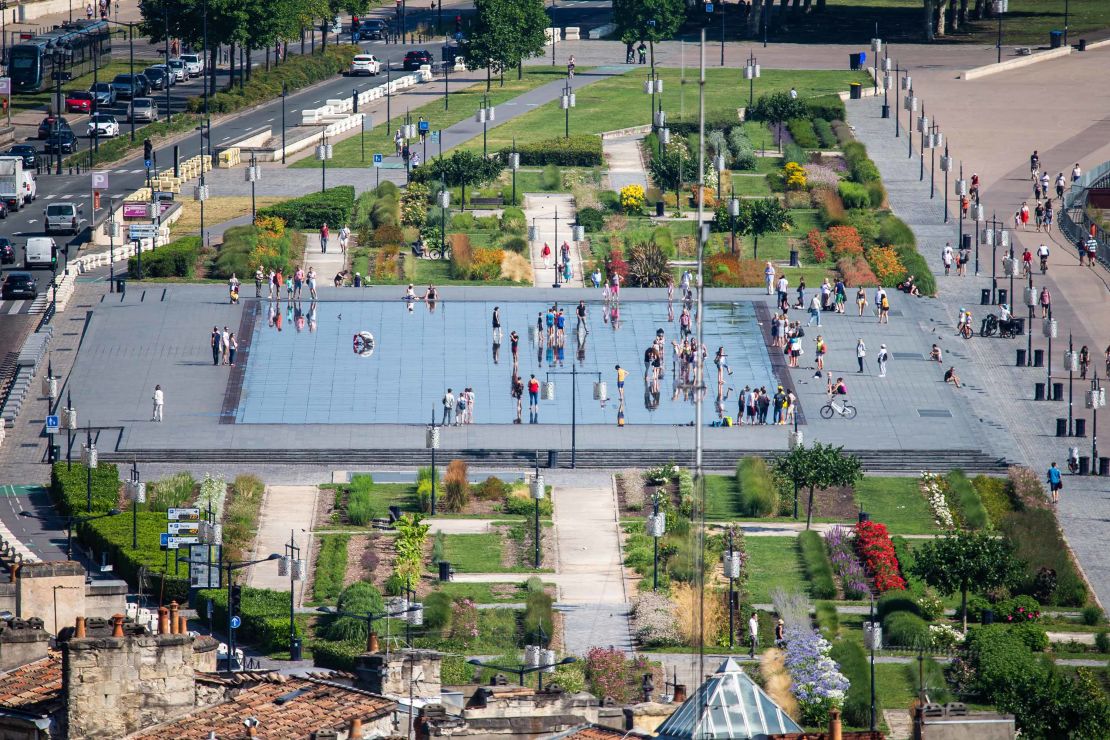 Bordeaux's reflection pool surrounded by gardens provides relief during the heatwave. 