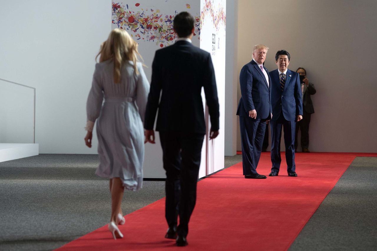 Ivanka Trump and Jared Kushner walk toward Donald Trump and Abe to join them for a photograph on Friday, the first day of the G20 summit.