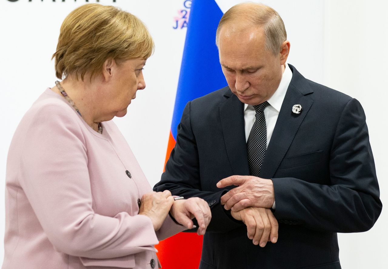 Merkel and Russian President Vladimir Putin look at their watches Saturday during a meeting on the sidelines of the G20 summit. 