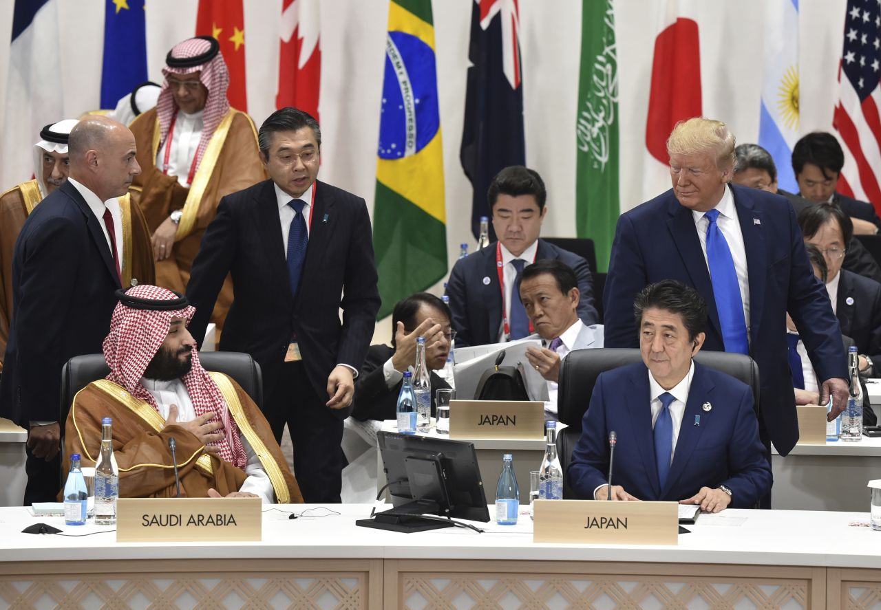 US President Donald Trump looks back at Saudi Arabia's Crown Prince Mohammed bin Salman, left, as Japan's Prime Minister Shinzo Abe, right bottom, looks on during a session Saturday at the G20 summit.