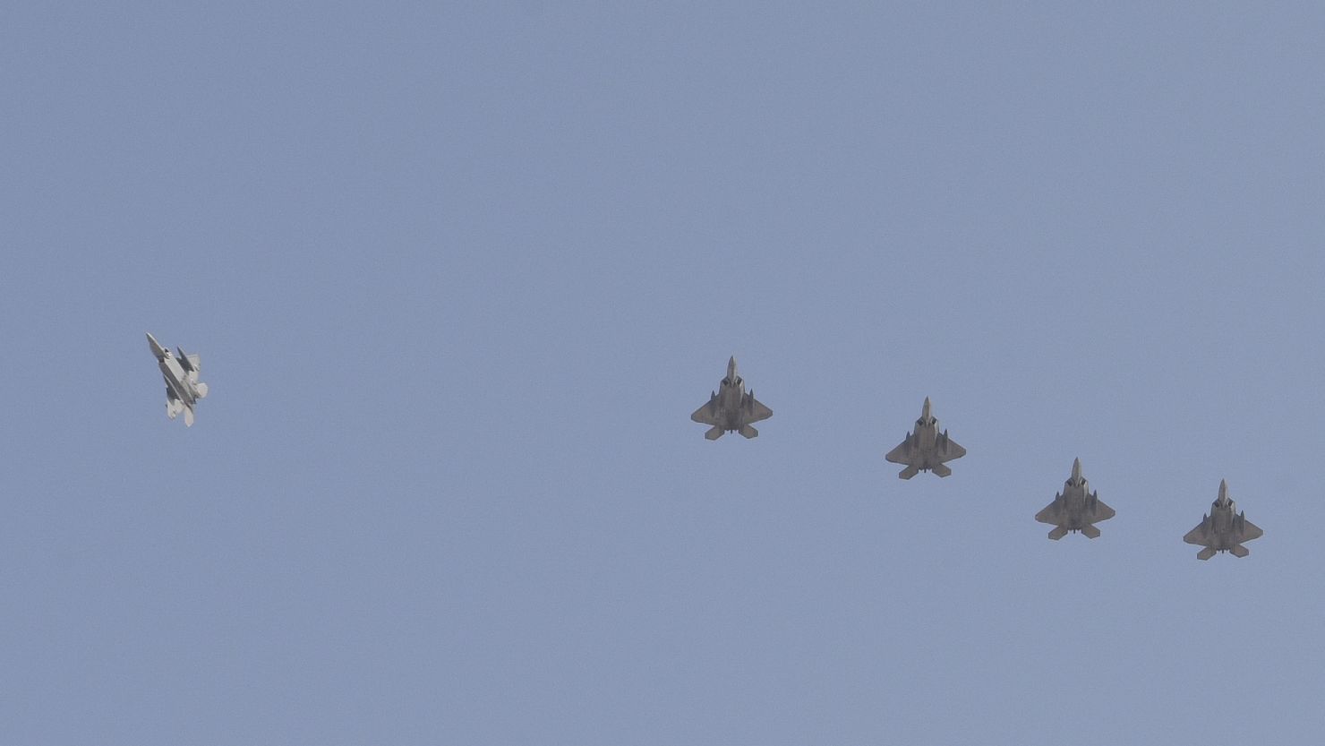 US Air Force F-22 Raptors fly in formation as they prepare to land at Al Udeid Air Base, Qatar, June 27, 2019. 
