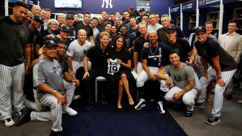 Harry and Meghan display the mini Yankees jersey the team gifted to their son Archie. 