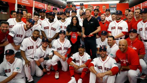Prince Harry and Meghan Markle pose with the Red Sox ahead of the first game of their London series.