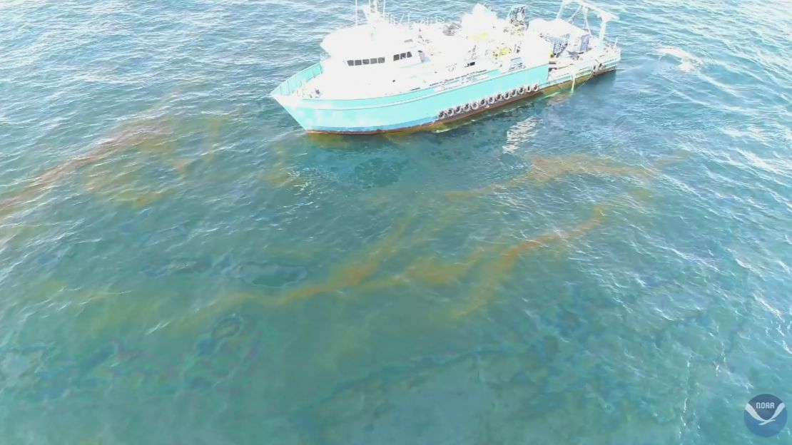 This September 2018 photo provided by NOAA shows a NOAA research vessel at a Taylor Energy production site in the Gulf of Mexico. A federally led study of oil seeping from the damaged platform found releases lower than other recent estimates, but contradicts the well owner's assertions about the amount and source of oil.