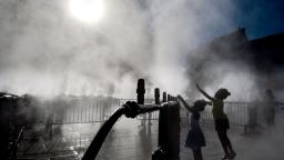 Children play next to a water atomizer on a central square in Strasbourg, eastern France on June 28, 2019. - The temperature in France on June 28 surpassed 45 degrees Celsius (113 degrees Fahrenheit) for the first time as Europe wilted in a major heatwave, state weather forecaster Meteo-France said. (Photo by PATRICK HERTZOG / AFP)        (Photo credit should read PATRICK HERTZOG/AFP/Getty Images)