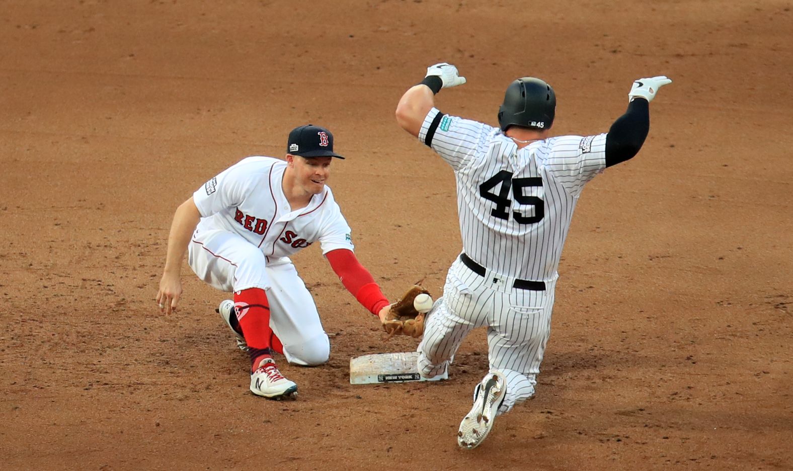 Red Sox infielder Brock Holt fails to hold onto the ball as Yankees first baseman Luke Voit slides into second base during game one of the MLB London series on June 29.