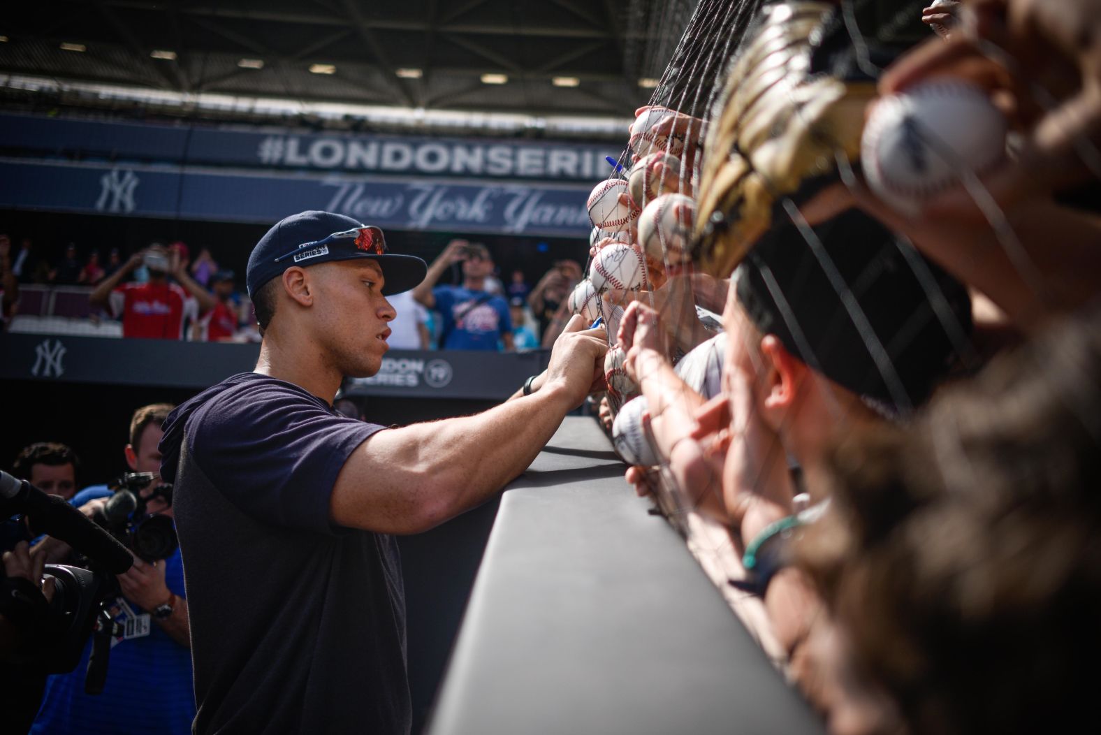 New York Yankees right fielder Aaron Judge signs autographs at the London Stadium on June 28.
