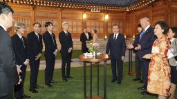 SEOUL, SOUTH KOREA - JUNE 29: In this handout image provided by South Korean Presidential Blue House, U.S. President Donald Trump talks with South Korean boy band EXO as South Korean President Moon Jae-in stands during a dinner at the presidential Blue House on June 29, 2019 in Seoul, South Korea. President Donald Trump is in South Korea from June 29-30 amid ongoing diplomatic activities surrounding North Korea's denuclearization. (Photo by South Korean Presidential Blue House via Getty Images)