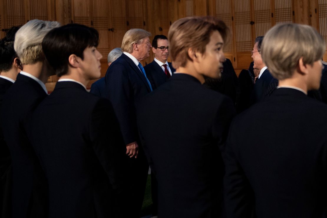 Members of K-pop band EXO stand while President Donald Trump, Treasury Secretary Steven Mnuchin and South Korean President Moon Jae-in wait at the presidential Blue House in Seoul on Saturday, June 29.