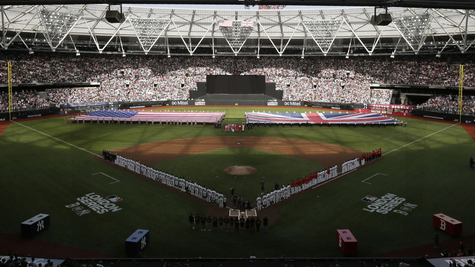 The New York Yankees and the Boston Red Sox stand for the United States' national anthem before the first of a two-game series at London Stadium on Saturday, June 29.