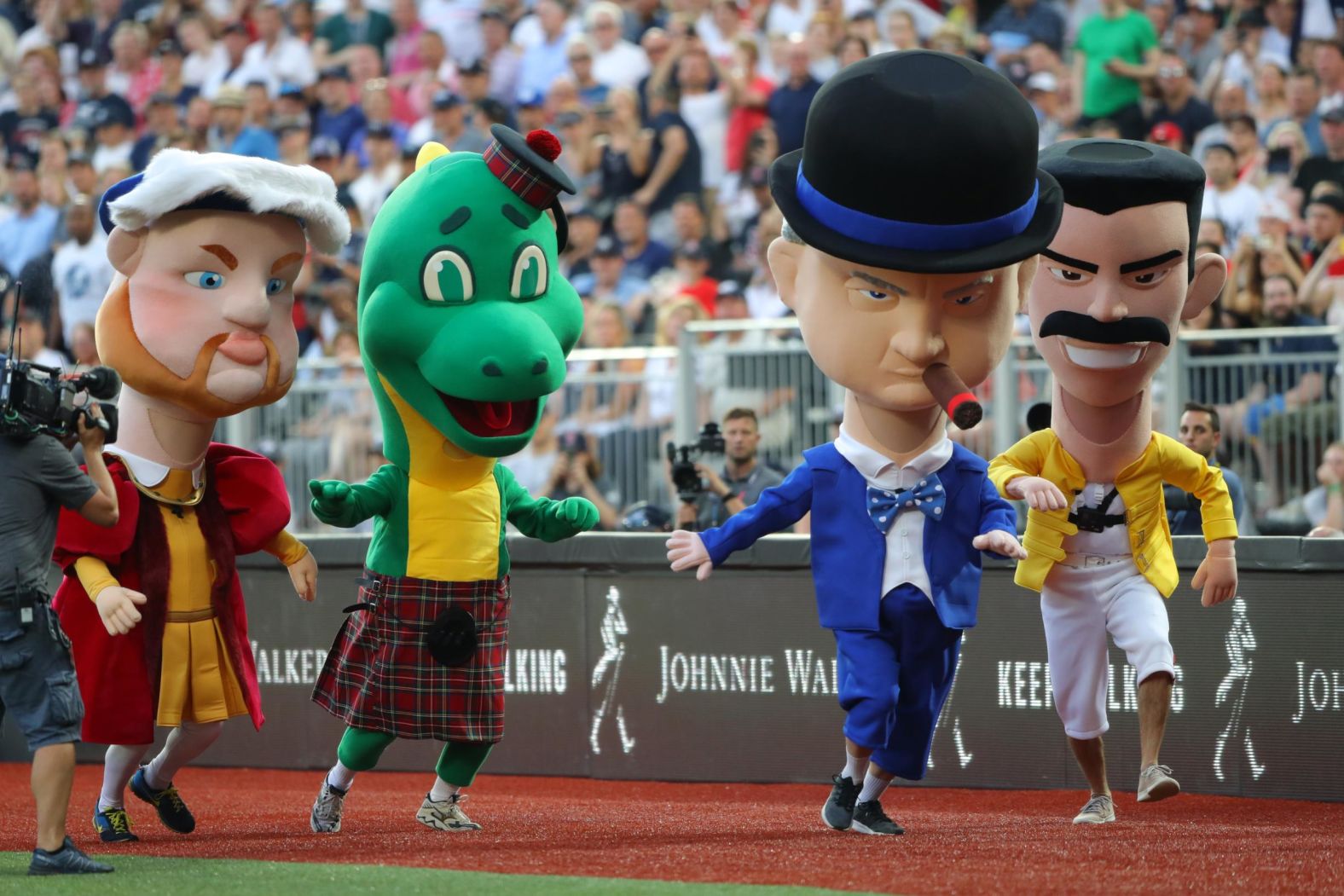 From left, giant mascots King Henry VIII, the Loch Ness Monster, Winston Churchill and Freddie Mercury race around the warning track at the end of the fourth inning of game one of the MLB London series on June 29.