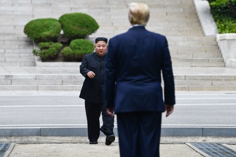North Korea's leader Kim Jong Un walks to greet US President Donald Trump at the Military Demarcation Line that divides North and South Korea, in the Joint Security Area (JSA) of Panmunjom in the Demilitarized Zone (DMZ) on Sunday, June 30.