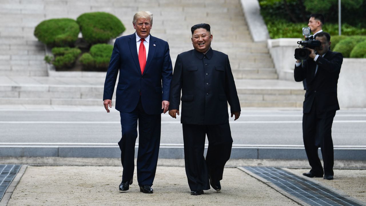 Kim Jong Un walks with Donald Trump at the DMZ dividing the Koreas on June 30, 2019.
