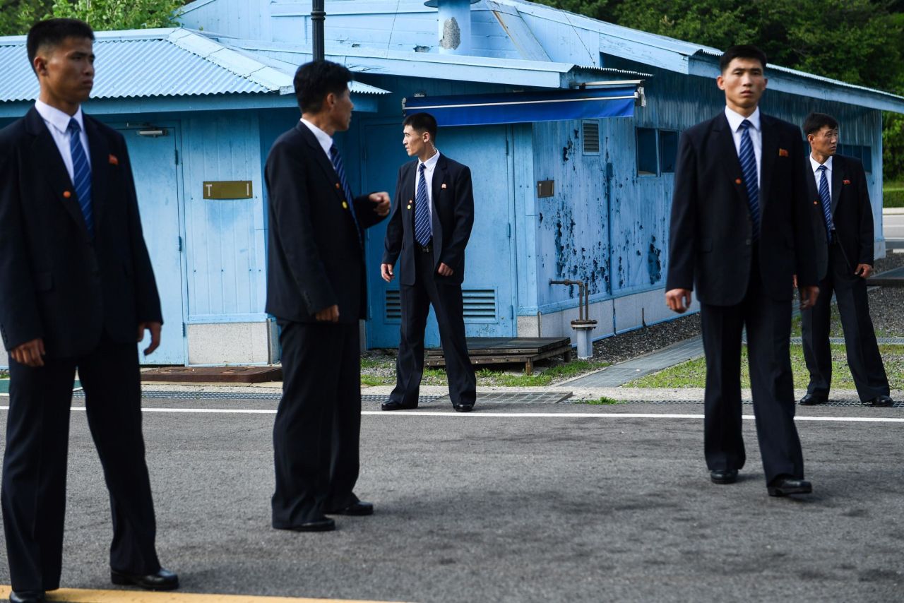 North Korean security agents keep watch south of the Military Demarcation Line that divides North and South Korea, as Trump and Kim meet in the Joint Security Area of Panmunjom in the Demilitarized zone on June 30.