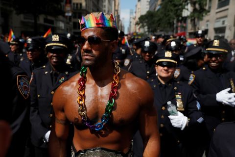 A man walks with New York City Police officers as they take part in the parade.